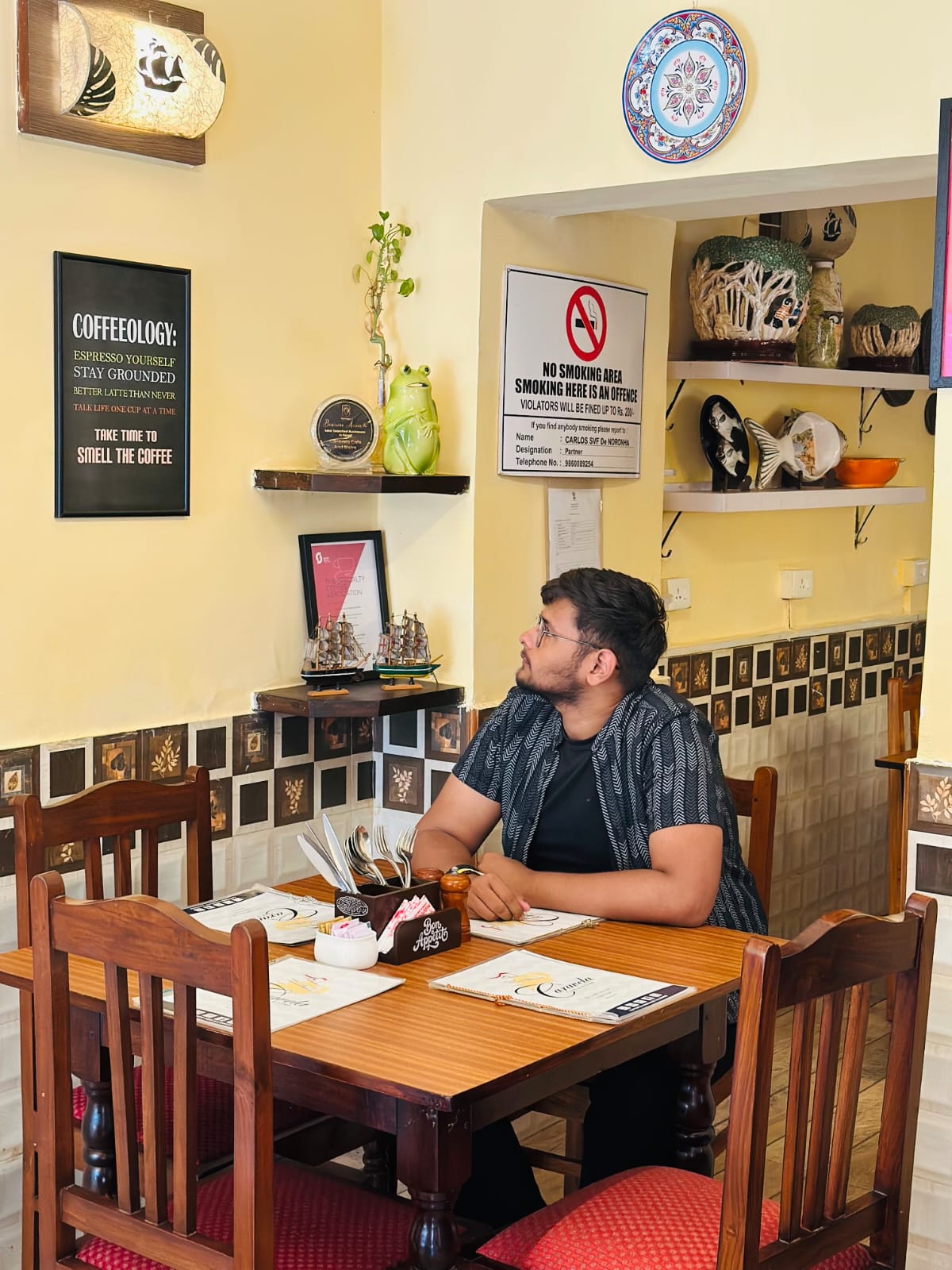 Koushal Sharma, a professional digital marketer and travel expert, sitting at a cafe table.